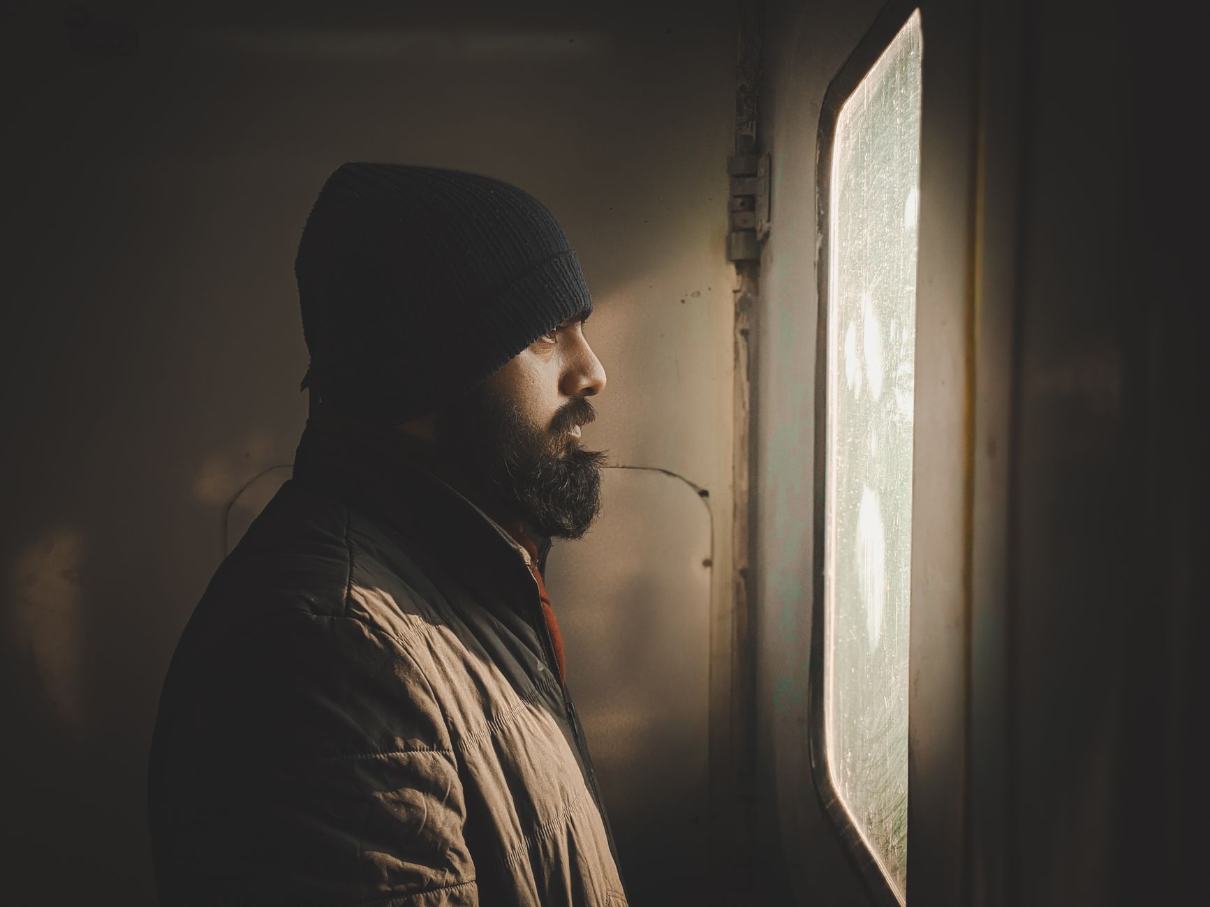 A man standing in a doorway lit from outside