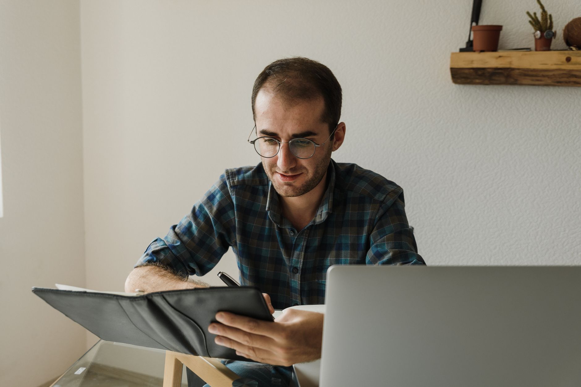 A man working at a laptop in a warm room