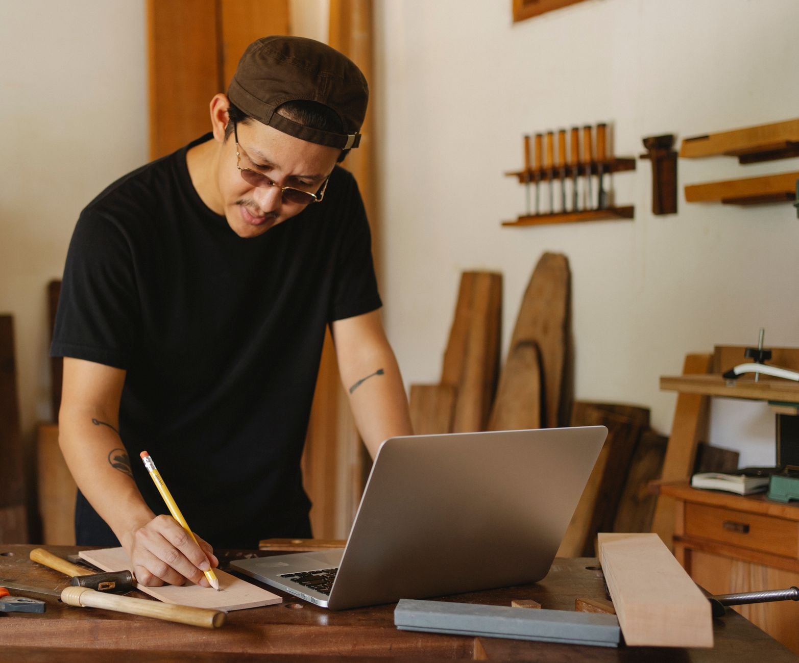 A man writing at a wooden desk