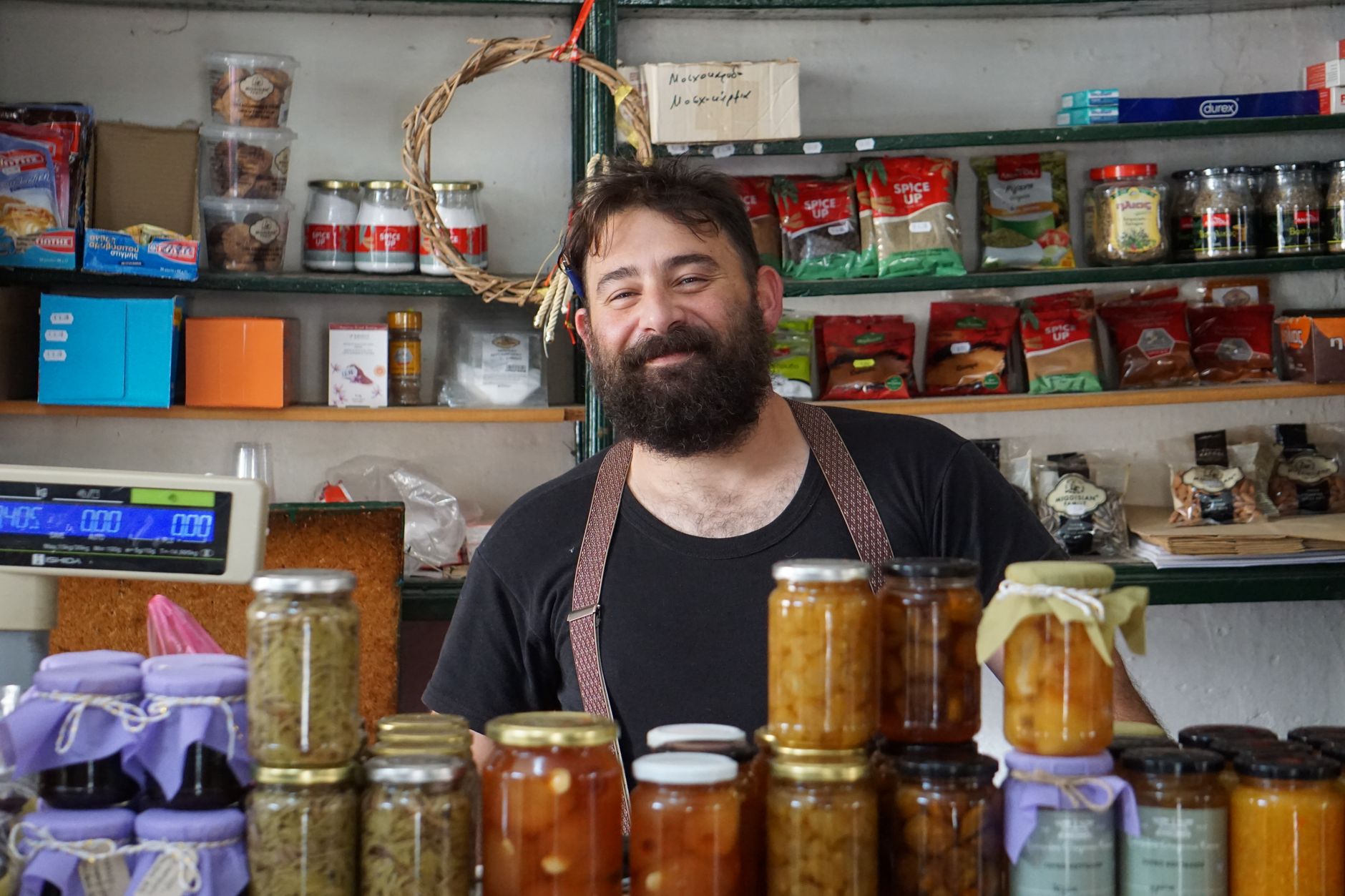 A shop owner standing behind his counter