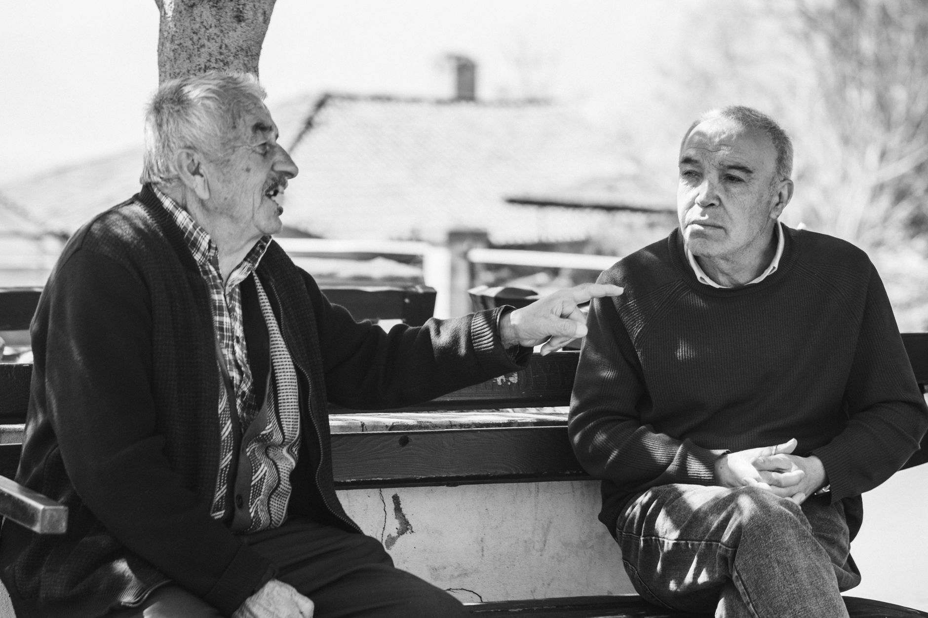Two older men in conversation, black and white